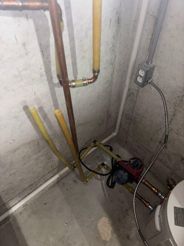 Responded to service call for tankless water heater system with reported hot water delivery issues throughout the residence. Upon arrival, verified that previous warranty company inspection had left the circuit breaker in the off position. Restored power to the tankless unit and confirmed proper electrical supply. Inspected hot water circulation pump located in utility area, verified operational status and electrical connections. Tested hot water delivery at multiple fixtures including kitchen sink to ensure adequate flow and temperature throughout the plumbing system. System restored to full operational status with immediate hot water availability at all points of use.