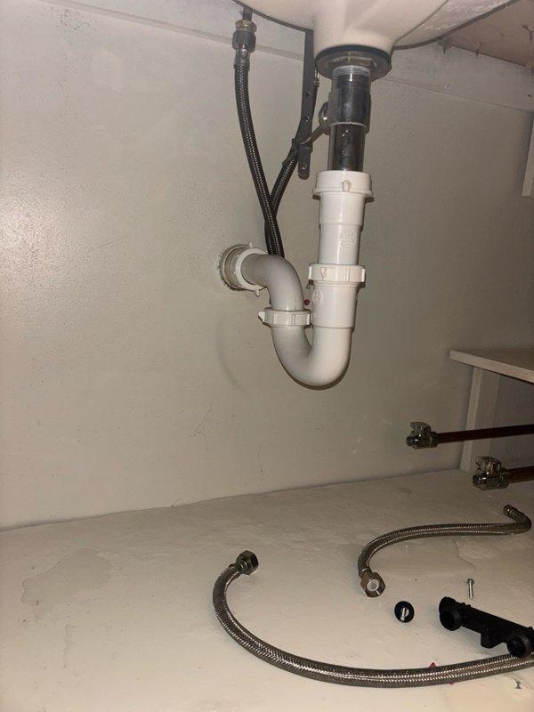 Responded to service call for tankless water heater system with reported hot water delivery issues throughout the residence. Upon arrival, verified that previous warranty company inspection had left the circuit breaker in the off position. Restored power to the tankless unit and confirmed proper electrical supply. Inspected hot water circulation pump located in utility area, verified operational status and electrical connections. Tested hot water delivery at multiple fixtures including kitchen sink to ensure adequate flow and temperature throughout the plumbing system. System restored to full operational status with immediate hot water availability at all points of use.
