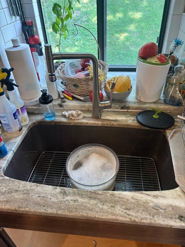 Conducted comprehensive inspection of whole home water conditioning system in response to reports of black grit contamination found in washing machine inlet filter. Examined under-sink plumbing assembly including manifold distribution system with braided stainless steel supply lines and compression fittings to assess potential sources of sediment. Inspected all visible plumbing connections, supply hoses, and water distribution points for signs of deterioration, corrosion, or debris accumulation that could contribute to particulate contamination in downstream fixtures. Evaluated kitchen sink installation and water delivery system to determine if conditioning equipment requires maintenance or replacement. Prepared detailed estimate for installation of dedicated hot water return line to accommodate tankless water heater recirculating pump system, including assessment of existing plumbing layout, routing requirements, and necessary materials for proper circulation loop implementation.