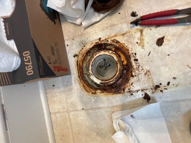 Responded to reported slow leak near toilet. Upon arrival, conducted thorough inspection of bathroom fixtures and surrounding areas. Identified severely corroded floor drain with extensive rust staining and deterioration of drain assembly. Documented conditions showing significant moisture damage and corrosion around drain fixture, indicating prolonged water exposure. Photographed toilet area, flooring, and corroded drain to document existing conditions and leak source location.