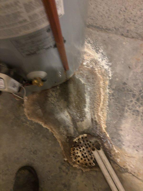 Responded to kitchen faucet failure with non-functioning shut-off valve on main floor. Upon inspection, discovered significant water damage and active moisture infiltration in utility area, with extensive staining visible on flooring surfaces near plumbing fixtures. Assessed copper supply lines, drainage system components, and associated shut-off mechanisms to determine extent of repair needed and document existing conditions for remediation.