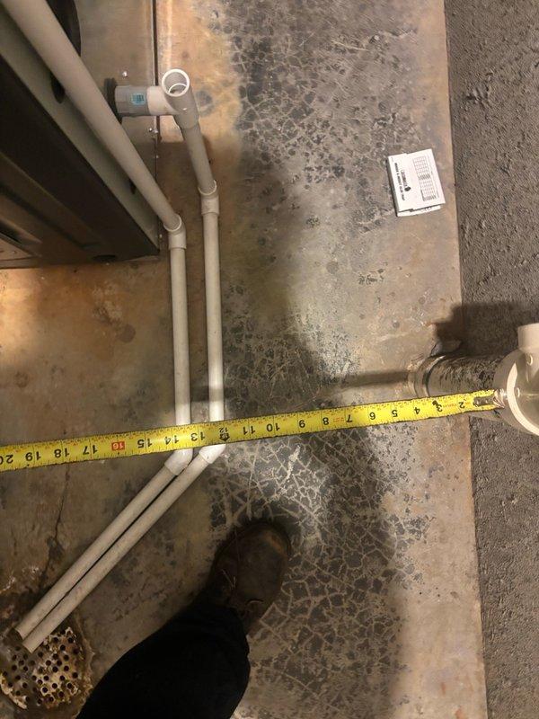 Responded to kitchen faucet failure with non-functioning shut-off valve on main floor. Upon inspection, discovered significant water damage and active moisture infiltration in utility area, with extensive staining visible on flooring surfaces near plumbing fixtures. Assessed copper supply lines, drainage system components, and associated shut-off mechanisms to determine extent of repair needed and document existing conditions for remediation.