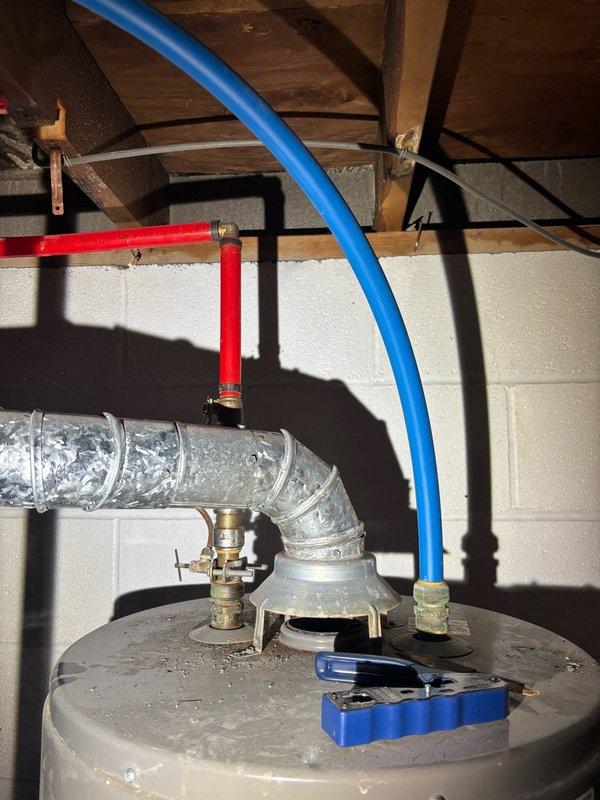 Responded to reported water heater leak in basement. Upon inspection, identified minor leakage at tank connections requiring approximately two towels to contain moisture. Assessed plumbing configuration including hot and cold water supply lines with appropriate color-coded piping, brass fittings, and venting system. Tightened connections at water heater tank interface and verified proper installation of expansion tank and associated valves. Tested system for additional leaks, confirmed proper operation, and ensured all connections were secure to prevent future water discharge.