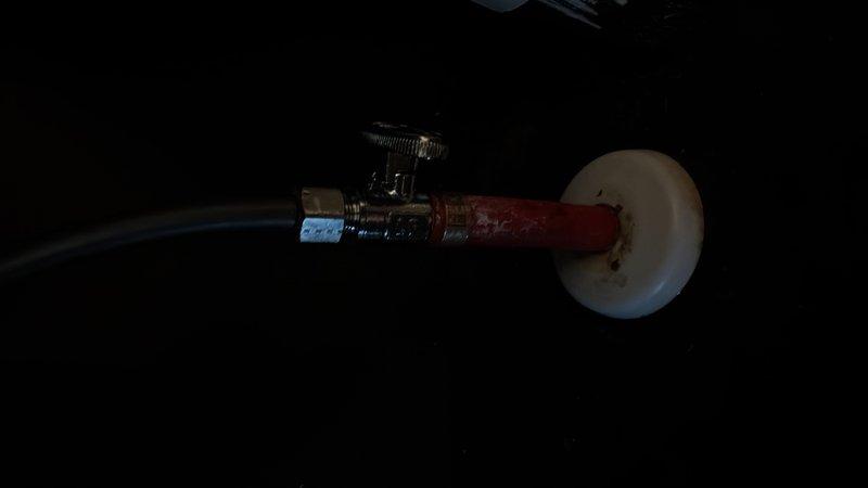 Responded to service call for gas line inspection at fireplace and multiple water leaks in bathroom and utility closet. Inspected gas line to fireplace and capped off as needed per customer request in preparation for home sale. Addressed water supply valve leak in bathroom, which showed signs of corrosion and deterioration on the shut-off valve assembly and copper supply line connections. Repaired or replaced corroded valve components exhibiting green patina and mineral buildup at threaded connections. Investigated water leak in utility closet adjacent to water heater and performed necessary repairs to eliminate active leaks. Documented all findings and repairs with photos for service records.