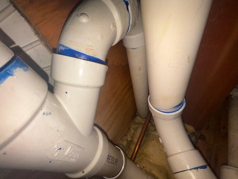 Responded to reported water leak in garage ceiling. Upon inspection, identified source of leak in plumbing system above garage area. Accessed affected piping through ceiling access point, located compromised PVC pipe connection with visible moisture damage to surrounding materials. Repaired leaking joint, secured all connections, and verified system integrity through pressure testing. Cleanup completed and area restored.