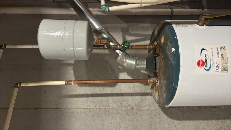 Responded to emergency call for no hot water and active water leak from existing water heater. Upon inspection, determined the unit had failed and required complete replacement. Removed and disposed of old water heater, then installed new residential water heater with proper venting and code-compliant connections. Installed new copper supply lines, pressure relief valve with discharge piping, expansion tank, and shutoff valves with green handles for easy identification. Verified all connections were secure and leak-free, tested system pressure using calibration gauge, and confirmed proper hot water delivery throughout the residence. System is now fully operational with all safety components properly installed and functioning.