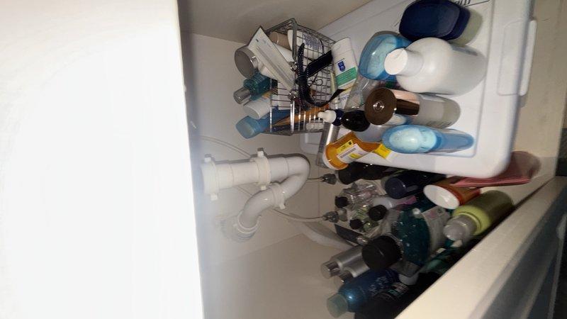 Completed routine plumbing maintenance inspection of residential property. Inspected HVAC-related copper piping with brass compression fittings in mechanical room, noting age-related discoloration on components but confirming system integrity. Examined bathroom vanity plumbing including sink drain assembly and PVC piping, verifying proper drainage and connection security with no leaks detected.