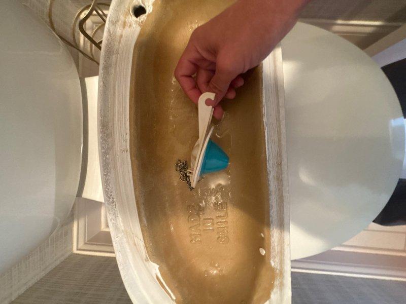 Completed installation of customer-supplied sump pump system to provide basement water removal and flood prevention. Replaced worn toilet flapper valve in beige pedestal toilet tank to restore proper flush operation and eliminate water waste from continuous running.