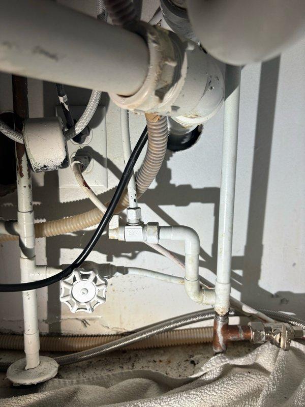 Responded to water leak complaint in kitchen area. Upon arrival, conducted thorough inspection of plumbing systems and fixtures to locate source of reported leak. Examined water heater installation and associated plumbing connections, including supply lines, flexible connectors, and shut-off valves. Inspected PVC piping, corrugated hoses, and metal fittings for signs of moisture, corrosion, or active leaking. Checked braided flexible supply lines and compression fittings for integrity. Extended inspection to adjacent bathroom facilities to rule out additional leak sources or related plumbing issues. Documented conditions of all accessible plumbing components with photographic evidence for service records. Completed comprehensive leak detection survey of affected areas.