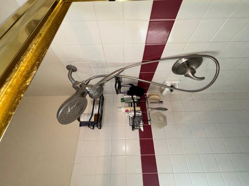 Installed customer-supplied shower valve rough-in assembly and reconstructed the shower P-trap system, replacing both 2-inch and 1½-inch drain piping to ensure proper drainage and code compliance. The installation included mounting the valve body, connecting supply lines, and verifying all connections for leaks prior to wall closure, with trim installation to be completed at a later date.