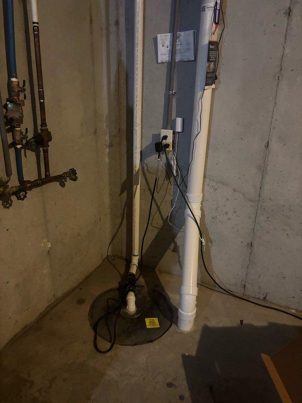 Installed a complete sump pump system in basement utility area featuring a 1/2 HP energy efficient permanent split capacitor (PSC) primary pump with capacity of 3,540 GPH at 10-foot lift and 4,400 GPH at zero lift, along with backup system rated at 1,850 GPH at 10-foot lift and 2,500 GPH at zero lift. Configured discharge piping using white PVC pipe with vertical run to wall outlet, established proper electrical connections to wall outlet, and verified system operation in existing sump basin. All components tested and functioning within manufacturer specifications.