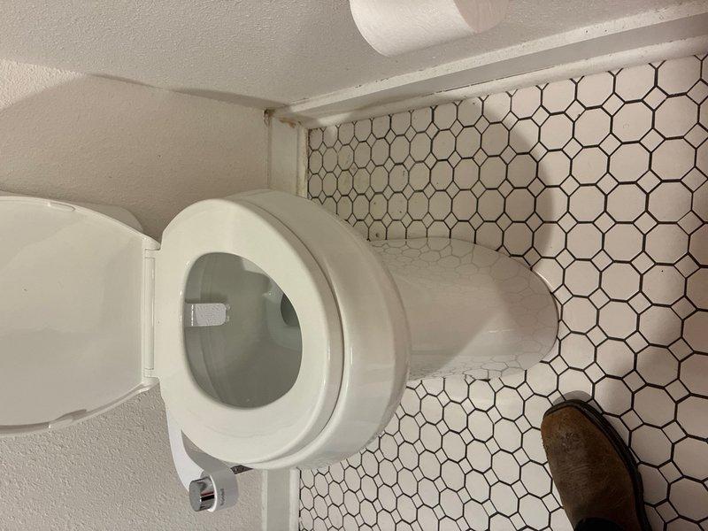 Installed customer-supplied toilet on main level bathroom. Removed existing fixture, set new toilet on hexagonal tile flooring, secured unit to flange, connected water supply line, and tested for proper operation and leaks. Installation completed successfully with no issues.