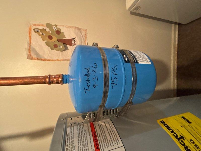 Responded to basement plumbing service call for clogged floor drain and leaking water heater. Upon inspection, addressed the main drain cleanout to restore proper drainage flow. Evaluated water heater system and associated components including expansion tank, pressure relief valve, and copper supply lines for source of reported leak. Documented equipment condition and plumbing configuration with detailed photographs for service records.