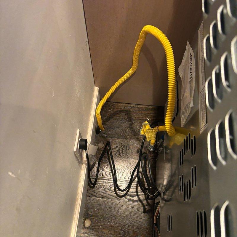 Responded to reported gas odor at tanked gas water heater in basement that began following recent HVAC service appointment. Upon inspection, identified yellow flexible gas line (CSST) routing and connections in utility area with multiple plumbing supply lines, drainage systems, and mechanical equipment. Performed thorough safety inspection of gas water heater installation, examined all gas line connections, fittings, and shutoff valves for proper installation and potential leak points. Verified proper venting configuration and clearances around unit to ensure safe operation and code compliance.