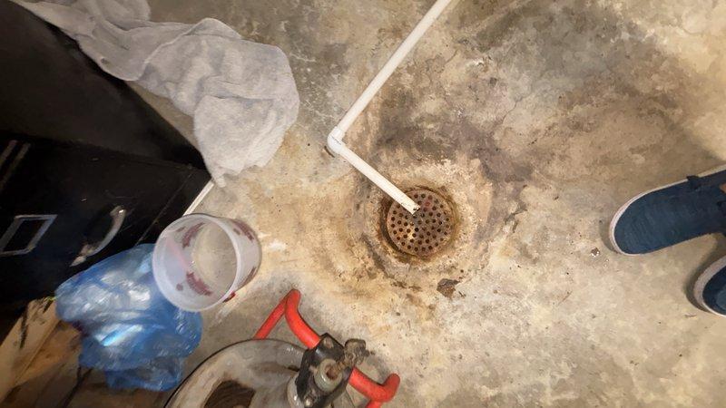 Responded to basement drain backup for non-member property. Performed main line cleanout through floor drain access point, removing obstruction causing sewage backup in basement area. Successfully cleared blockage and restored proper drainage flow through main sewer line.