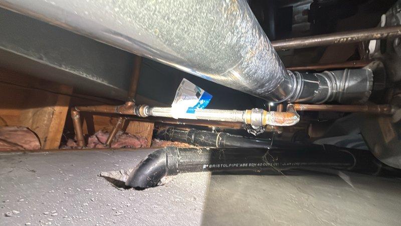 Responded to a water leak in a copper pipe located above the hot water heater in the crawl space. Upon arrival, found that a previous repair attempt had been unsuccessful. Accessed the affected area and identified the leak point on the copper supply line. Shut off the water supply to isolate the section requiring repair. Cut out the damaged portion of the copper pipe and prepared clean pipe ends for repair. Installed a new section of copper pipe using proper fitting techniques and secured connections with appropriate solder joints. Tested all connections for leaks and verified proper water flow restoration. Inspected surrounding pipes and mechanical systems for any additional concerns. Restored water supply and confirmed system operation with no further leakage detected.