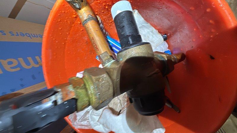 Responded to low water pressure complaint affecting entire residential property. Upon investigation, diagnosed insufficient pressure at main water supply line using pressure gauge, which confirmed readings near zero PSI. Replaced faulty pressure regulator valve and associated brass fittings to restore proper water pressure throughout the home.