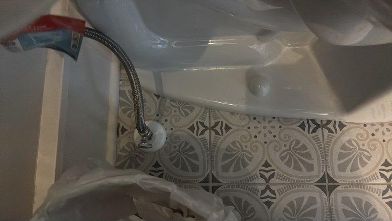 Responded to guest bathroom for customer-provided toilet installation. Removed existing toilet fixture, including disconnection of water supply line and wax ring removal. Prepared flange and floor surface for new installation. Set new toilet unit with fresh wax ring seal, ensuring proper alignment with floor flange and decorative tile pattern. Connected braided stainless steel supply line to fill valve and shut-off valve. Secured toilet to floor with closet bolts and tested for proper seating. Turned on water supply, filled tank, and performed multiple flush cycles to verify proper operation and check for leaks at supply connection, tank-to-bowl seal, and base. Confirmed stable installation and no water seepage. Installation completed successfully with all connections secure and fixture functioning properly.