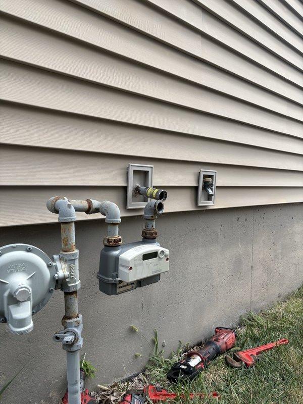 Installed new gas line from existing meter to fire pit location. Ran 1" black iron pipe along foundation wall, reduced to 3/4" black iron, then transitioned to 3/4" yellow polyethylene pipe for underground run with stub-up above grade at termination point. Coordinated with pool company for trenching and excavation work. Completed pressure testing and leak check of entire installation to verify system integrity and code compliance.
