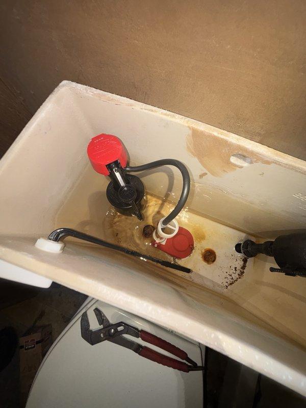 Responded to service call for no hot water and malfunctioning toilet flush valve in main bathroom. Inspected gas-fired A.O. Smith water heater in basement utility area and verified lack of hot water production throughout home. Examined toilet tank components and identified failed flush valve requiring replacement due to mineral buildup and component wear. Replaced defective flush valve assembly with new unit, tested flushing mechanism for proper operation, and verified tank refill cycle functioning correctly.