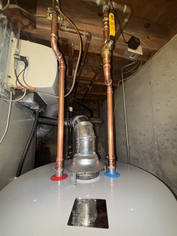 Successfully installed a 50-gallon gas water heater with thermal expansion tank in the utility area. Completed single wall flue rework up to 4 feet to ensure proper venting. All copper supply lines were connected with shutoff valves, gas line was properly fitted with shutoff valve, and the system was tested for proper operation and safety compliance.