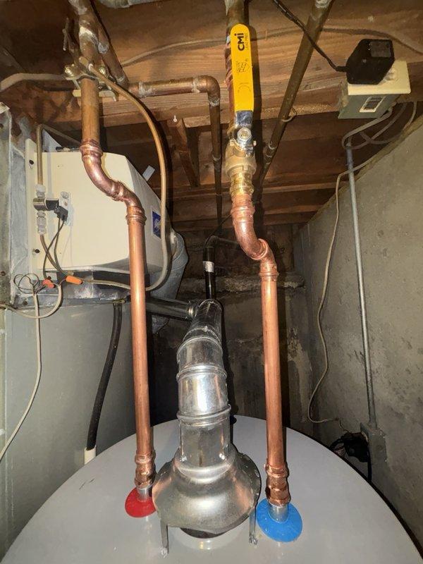 Successfully installed a 50-gallon gas water heater with thermal expansion tank in the utility area. Completed single wall flue rework up to 4 feet to ensure proper venting. All copper supply lines were connected with shutoff valves, gas line was properly fitted with shutoff valve, and the system was tested for proper operation and safety compliance.