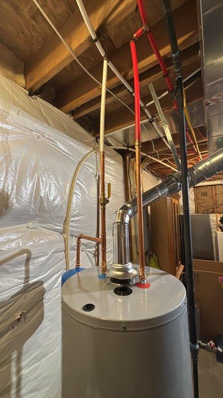 Completed installation of a 50-gallon gas-fired water heater in basement utility space. Installed thermal expansion tank to protect against excessive pressure buildup in the closed plumbing system. Connected all necessary copper supply lines with proper shut-off valves and installed pressure relief valve with discharge piping. Configured gas supply connection and venting system using code-compliant black pipe and galvanized vent piping with appropriate elbow fittings to ensure safe exhaust of combustion gases. All plumbing connections were pressure-tested and verified for proper operation. Unit was commissioned and confirmed to be heating water efficiently with no leaks detected at any connection points.