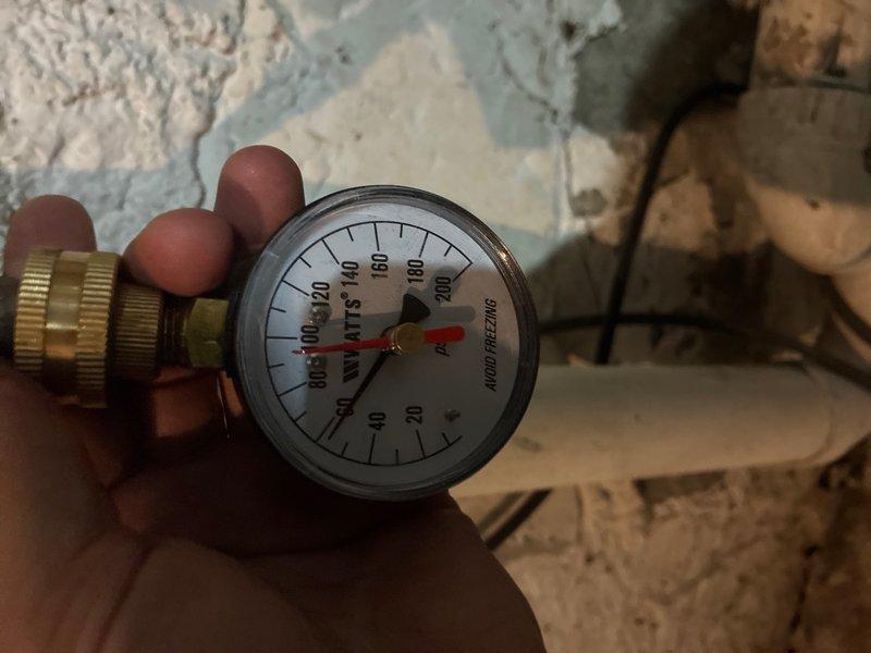 Responded to service call for malfunctioning water heater temperature regulator in basement location. Upon arrival, performed diagnostic assessment of tanked water heater system and associated components. Tested water pressure using calibration gauge to establish baseline system parameters and identify potential contributing factors to temperature regulation failure. 

Inspected copper supply lines, shut-off valves, and connection points for proper operation and signs of deterioration. Examined temperature and pressure relief valve functionality and verified proper installation of flexible connector at tank base. Evaluated condition of existing piping infrastructure, including valve controls and brass fittings throughout the system.

Replaced defective temperature regulator component, restoring proper thermostat control functionality to the water heater unit. Verified all connections were secure and system was operating within normal parameters. Tested hot water output temperature at m