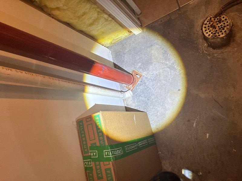 Conducted on-site assessment of laundry room floor drain installation. Upon inspection, identified that existing floor drain lacks proper drain pan and associated piping connections required for functional operation. Evaluated existing plumbing infrastructure including visible PVC Schedule 40 piping and drainage components in the utility space. Documented current conditions through photographic evidence showing concrete floor installation, exposed drain grate, and surrounding mechanical systems including HVAC ductwork and condensate lines in overhead spaces. Prepared estimate for installation of compliant drain pan system with proper piping connections to establish functional drainage for laundry room floor drain per plumbing code requirements.