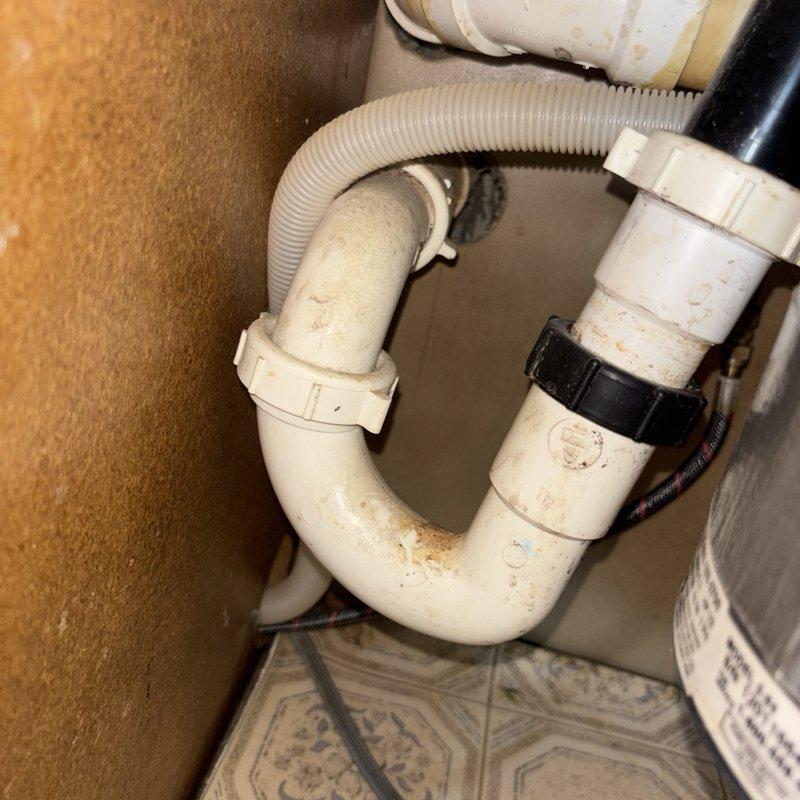Responded to service call for non-functional garbage disposal unit. Upon inspection, found existing InSinkErator disposal unit inoperative beneath kitchen sink. Assessed existing plumbing configuration including P-trap assembly and drain connections. Removed failed disposal unit and installed new replacement unit, ensuring proper mounting to sink flange and secure connection to existing drain line and dishwasher discharge hose. Tested new disposal for proper operation, verified all connections for leaks, and confirmed drainage functionality.