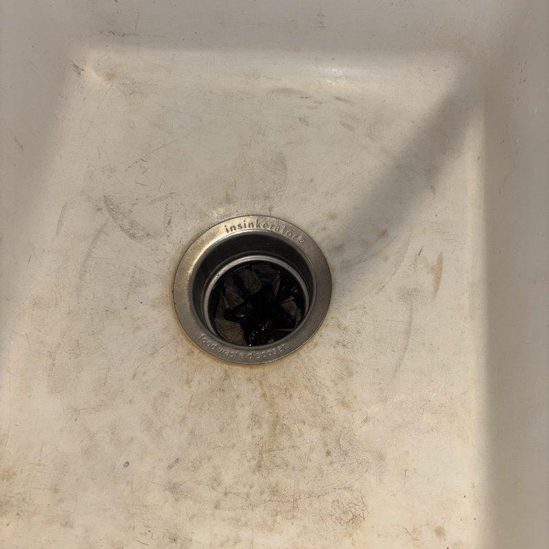 Responded to service call for non-functional garbage disposal unit. Upon inspection, found existing InSinkErator disposal unit inoperative beneath kitchen sink. Assessed existing plumbing configuration including P-trap assembly and drain connections. Removed failed disposal unit and installed new replacement unit, ensuring proper mounting to sink flange and secure connection to existing drain line and dishwasher discharge hose. Tested new disposal for proper operation, verified all connections for leaks, and confirmed drainage functionality.