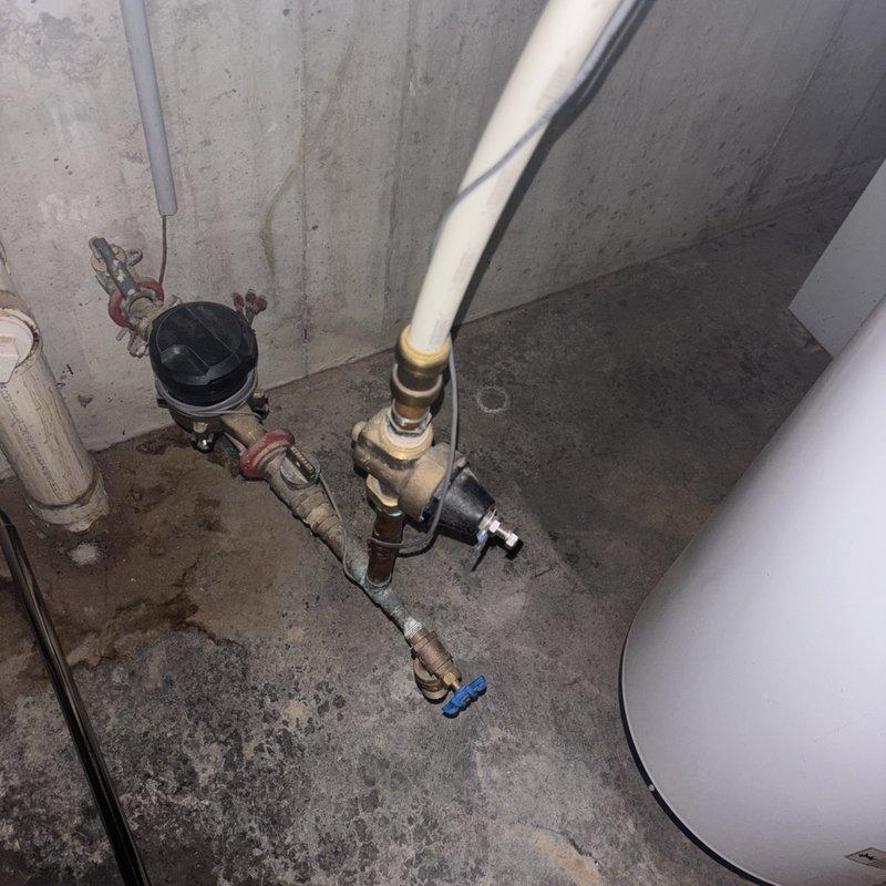 Responded to service call for non-operational gas water heater in basement. Upon arrival, performed diagnostic assessment of existing gas-fired tanked water heater system. Inspected gas supply line connections, pilot assembly, thermocouple, and main burner operation. Evaluated associated plumbing connections including cold water inlet with shutoff valve, hot water outlet, temperature and pressure relief valve, and gas control valve. Checked for proper venting and combustion air supply. Assessed water treatment system components including dual water softener tanks and brine reservoir to ensure no interference with water heater operation. Verified proper function of expansion tank and pressure regulation equipment in the plumbing assembly. Completed necessary repairs to restore hot water service. System tested and confirmed operational before departure.