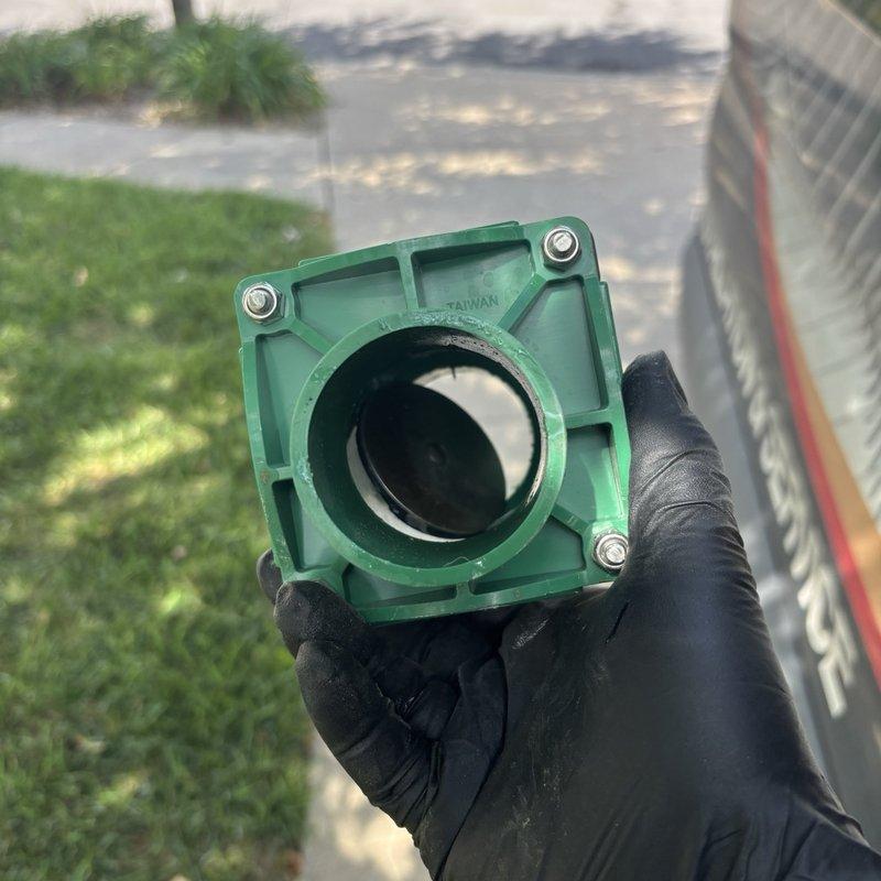 Responded to grinder pump malfunction in basement with suspected float or switch failure. Upon inspection, diagnosed faulty float switch assembly preventing proper pump operation. Removed defective green plastic float housing and replaced malfunctioning 2" Legend Valve component. Tested system operation to verify proper cycling and confirmed pump activated and deactivated correctly at appropriate water levels.