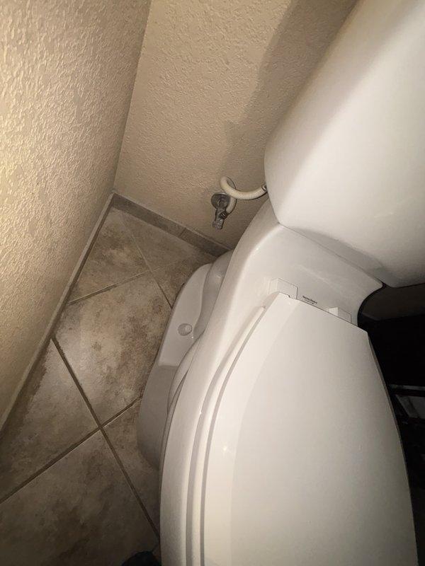 Responded to reported odor complaint originating from toilet in bathroom. Upon arrival, conducted thorough inspection of toilet fixture, wax ring seal, and flange connection. Identified source of smell as compromised wax ring seal at base of toilet allowing sewer gases to escape into bathroom. Removed toilet from floor flange, scraped old wax ring material, inspected flange for damage, and confirmed proper flange condition. Installed new wax ring seal and reset toilet to floor flange, ensuring proper alignment and secure mounting. Reconnected water supply line, tested flush operation, and verified complete seal with no leaks or odors present. Issue resolved successfully.