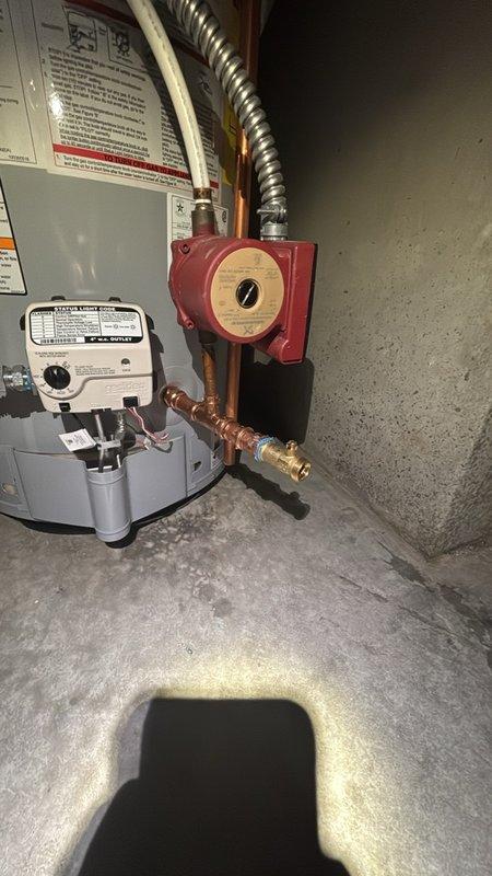 Completed installation of a 50-gallon residential gas water heater in basement utility area, including all required plumbing connections with copper piping and proper fittings. Installed thermal expansion tank with appropriate mounting and copper line connections to protect the system from pressure buildup. Connected gas supply line with shut-off valve and established proper venting through metallic flue pipe to existing ductwork. Additionally performed swap-out of existing Matrix MX water softener system, ensuring proper integration with the new water heater installation. Installed recirculation pump with copper piping connections to facilitate hot water circulation throughout the residence. All connections were tested and verified for proper operation, with no leaks detected at any junction points.