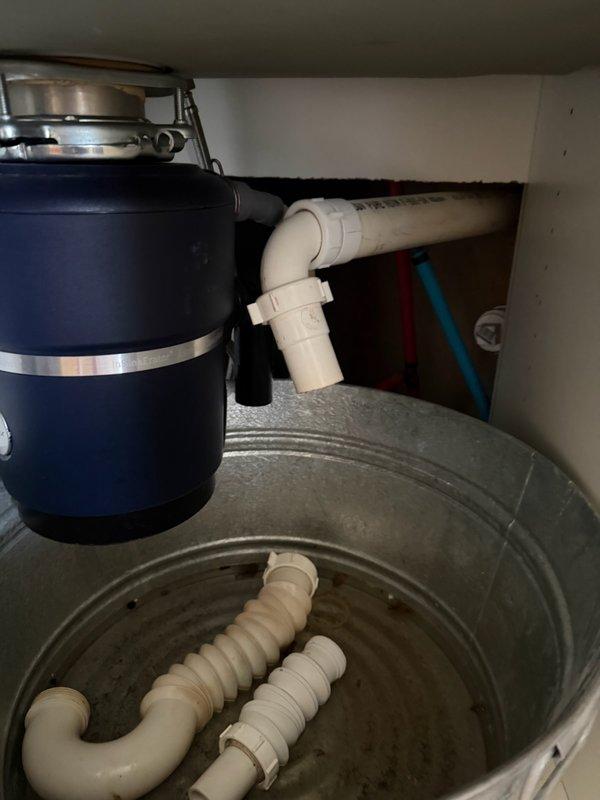 Responded to service call for plumbing repairs in kitchen and bathroom areas. Replaced defective P-trap assembly under kitchen sink connected to garbage disposal unit, ensuring proper drainage and eliminating leaks in the PVC drain system. Installed extended tailpiece and elbow fitting in bathroom vanity cabinet to correct improper drain configuration and achieve proper alignment with existing trap assembly. All connections tested and verified leak-free upon completion.