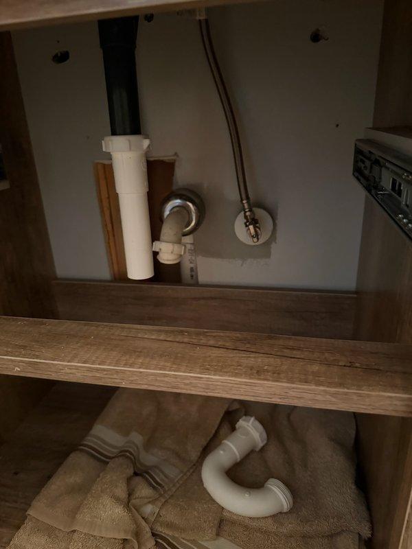 Responded to service call for plumbing repairs in kitchen and bathroom areas. Replaced defective P-trap assembly under kitchen sink connected to garbage disposal unit, ensuring proper drainage and eliminating leaks in the PVC drain system. Installed extended tailpiece and elbow fitting in bathroom vanity cabinet to correct improper drain configuration and achieve proper alignment with existing trap assembly. All connections tested and verified leak-free upon completion.
