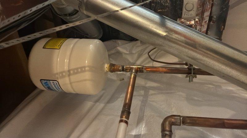 Conducted on-site assessment of 12-year-old gas water heater in basement to provide replacement estimate for 50-gallon capacity unit. Inspected existing installation including pressure gauge readings, expansion tank condition, copper supply lines, gas connections, and venting system. Documented current system configuration and photographed equipment to develop comprehensive replacement proposal.