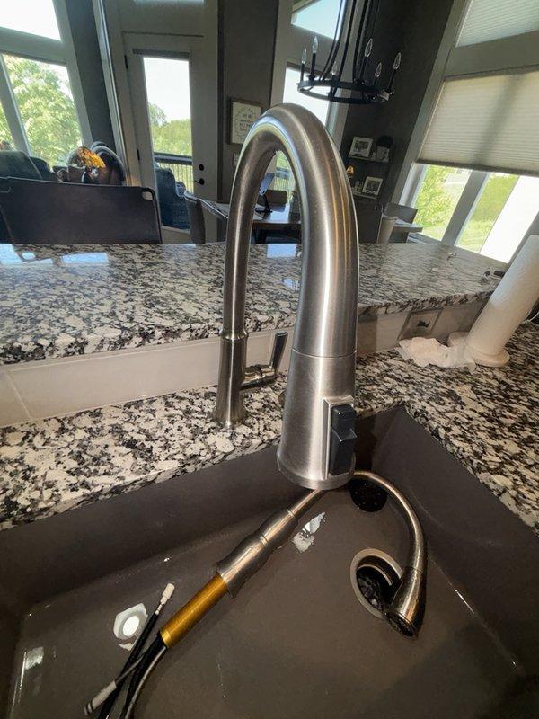 Responded to kitchen faucet repair request where handle was reported broken and required replacement. Successfully installed new brushed stainless steel pull-down faucet with contemporary curved spout design, replacing the damaged unit. Verified proper operation of pull-down spray head, water flow, and handle functionality upon completion.