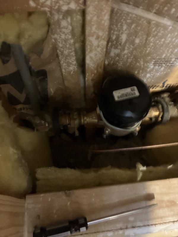 Completed comprehensive plumbing inspection of residential property, documenting condition of water supply system components including pressure tank, brass fittings, and valves in utility space. Identified and photographed significant damage to bathroom sink basin, including large crack with missing ceramic material requiring replacement, and documented all findings for customer review.