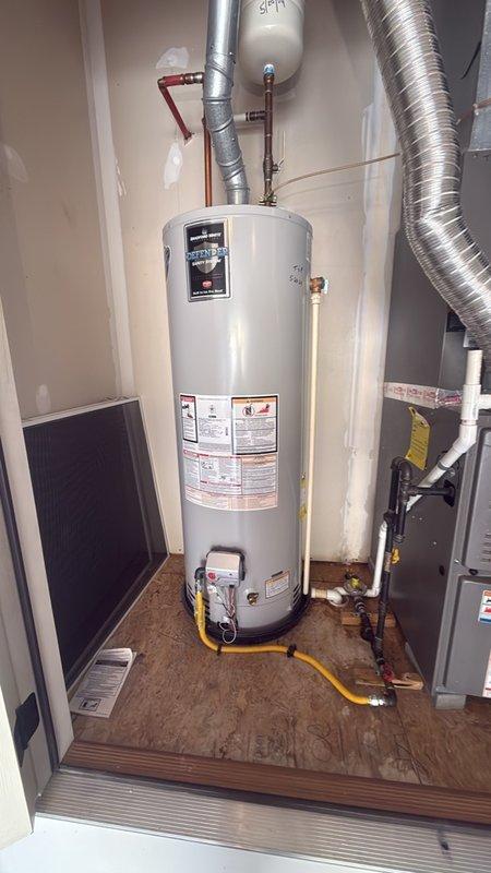 Responded to urgent call for water leak near furnace and hot water heater in utility closet. Upon inspection, examined all copper piping, connections, and fittings throughout the mechanical space, including water heater supply lines with yellow insulation sleeves and pressure relief valve assembly. Thoroughly inspected flexible ductwork connections, PVC drainage and venting systems, and all visible plumbing joints for signs of active leakage or moisture. Checked water heater tank exterior, control panel area, and base connections where copper pipes with brass fittings connect to unit. No active leak was identified during the inspection period; all connections, joints, and fixtures appeared dry with no visible water damage, staining, or moisture accumulation on flooring or surrounding surfaces. Documented existing plumbing configuration with photographs for reference. Advised that intermittent leaks can be difficult to diagnose without active water flow and recommended monitoring the ar