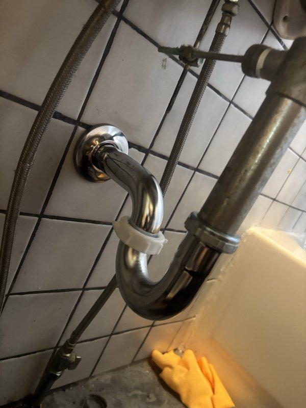 Responded to service call for corroded bathroom sink pipework replacement. Upon inspection, found existing chrome P-trap and drain assembly had significant corrosion preventing proper disassembly and repair. Successfully removed deteriorated plumbing components and installed new P-trap assembly beneath pedestal sink. Verified all connections for proper seal and tested drainage system to ensure full functionality. All new fixtures installed and system operational.