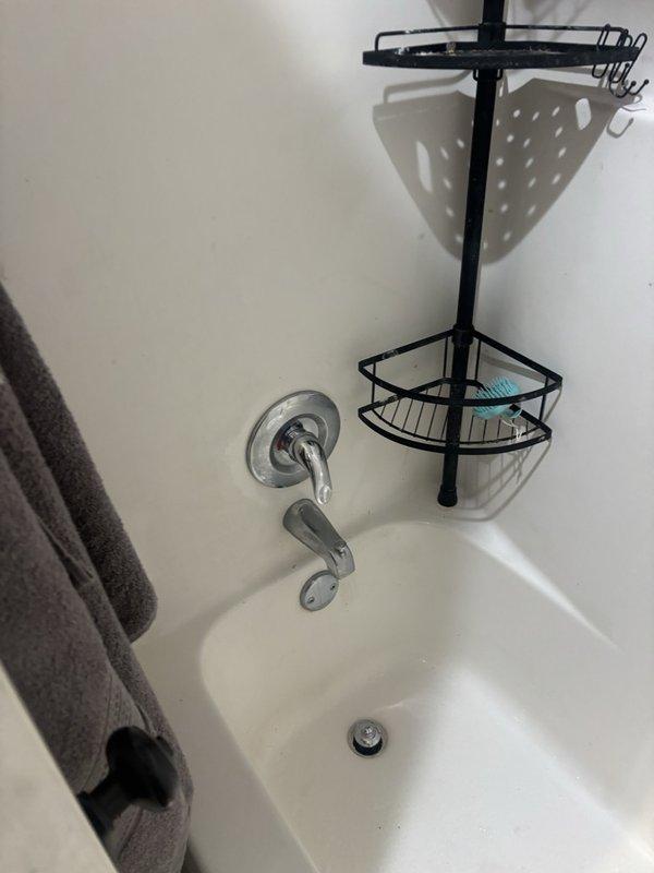 Responded to emergency plumbing service call for main water shut-off valve in basement utility room that was leaking a continuous stream due to broken handle. Replaced defective shut-off valve with new lever-style ball valve, ensuring proper seal and operation to eliminate leak. Additionally inspected bathtub faucet assembly at customer's request and confirmed proper function of single-handle chrome fixture with no repairs needed at that location.