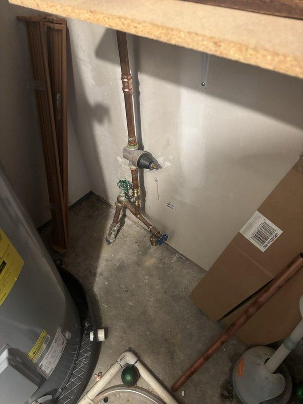 Responded to emergency plumbing service call for main water shut-off valve in basement utility room that was leaking a continuous stream due to broken handle. Replaced defective shut-off valve with new lever-style ball valve, ensuring proper seal and operation to eliminate leak. Additionally inspected bathtub faucet assembly at customer's request and confirmed proper function of single-handle chrome fixture with no repairs needed at that location.