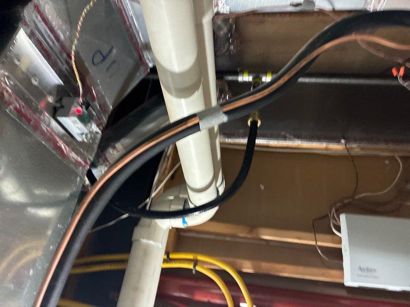 Completed installation of Rinnai RX199 tankless water heater system in attic space. Installation included routing copper supply lines, gas line connections with flexible yellow CSST tubing, condensate drainage via PVC piping, and exhaust venting with appropriate termination. All connections tested and system commissioned for proper operation.