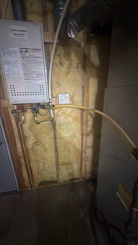 Responded to address improperly bonded CSST (Corrugated Stainless Steel Tubing) gas line serving tankless water heater installation. Upon inspection, confirmed yellow flexible gas line lacked required electrical bonding to protect against lightning strikes and electrical surges per manufacturer specifications and code requirements. Installed approved bonding clamp and grounding conductor to establish proper electrical continuity between CSST gas piping system and electrical grounding system. Verified secure connections at bonding points and confirmed compliance with NFPA 54 and manufacturer guidelines for gas line protection in residential utility area.