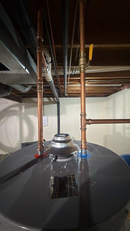 Completed installation of a 50-gallon gas-fired water heater in the basement utility area with all necessary connections and safety components. Installed a thermal expansion tank to protect the system from excessive pressure buildup caused by thermal expansion within the closed plumbing system. Configured all copper supply piping with proper fittings, valves, and connections to ensure reliable hot water delivery throughout the residence. The installation includes a temperature and pressure relief valve with discharge piping for safety compliance, gas supply connections, and proper venting to exhaust combustion gases safely from the space. All plumbing connections were professionally soldered and secured, with shut-off valves installed for future maintenance accessibility.