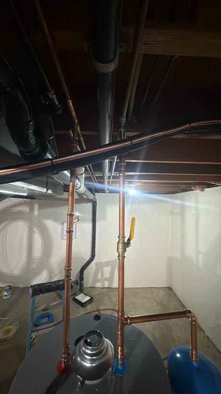 Completed installation of a 50-gallon gas-fired water heater in the basement utility area with all necessary connections and safety components. Installed a thermal expansion tank to protect the system from excessive pressure buildup caused by thermal expansion within the closed plumbing system. Configured all copper supply piping with proper fittings, valves, and connections to ensure reliable hot water delivery throughout the residence. The installation includes a temperature and pressure relief valve with discharge piping for safety compliance, gas supply connections, and proper venting to exhaust combustion gases safely from the space. All plumbing connections were professionally soldered and secured, with shut-off valves installed for future maintenance accessibility.