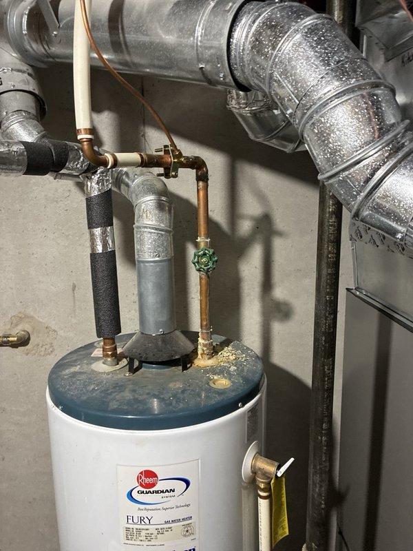 Performed routine plumbing maintenance inspection on residential Guardian water heater system. Evaluated system pressure using calibrated gauge, verified proper operation of shut-off valves and brass fittings, and documented existing copper pipe connections with insulation. All components found to be functioning within normal parameters.