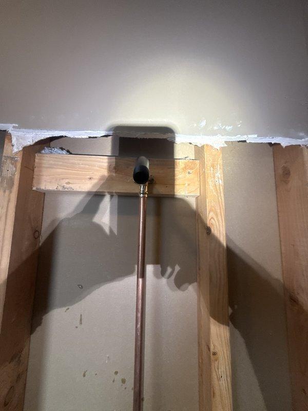 Replaced defective shower valve in main floor bathroom. Removed section of drywall to access existing plumbing assembly behind wall studs. Disconnected old mixing valve from copper supply lines and installed new valve assembly, ensuring proper connections to hot and cold water supplies and connection to shower head outlet. Tested new valve for proper operation and verified no leaks at all connection points.